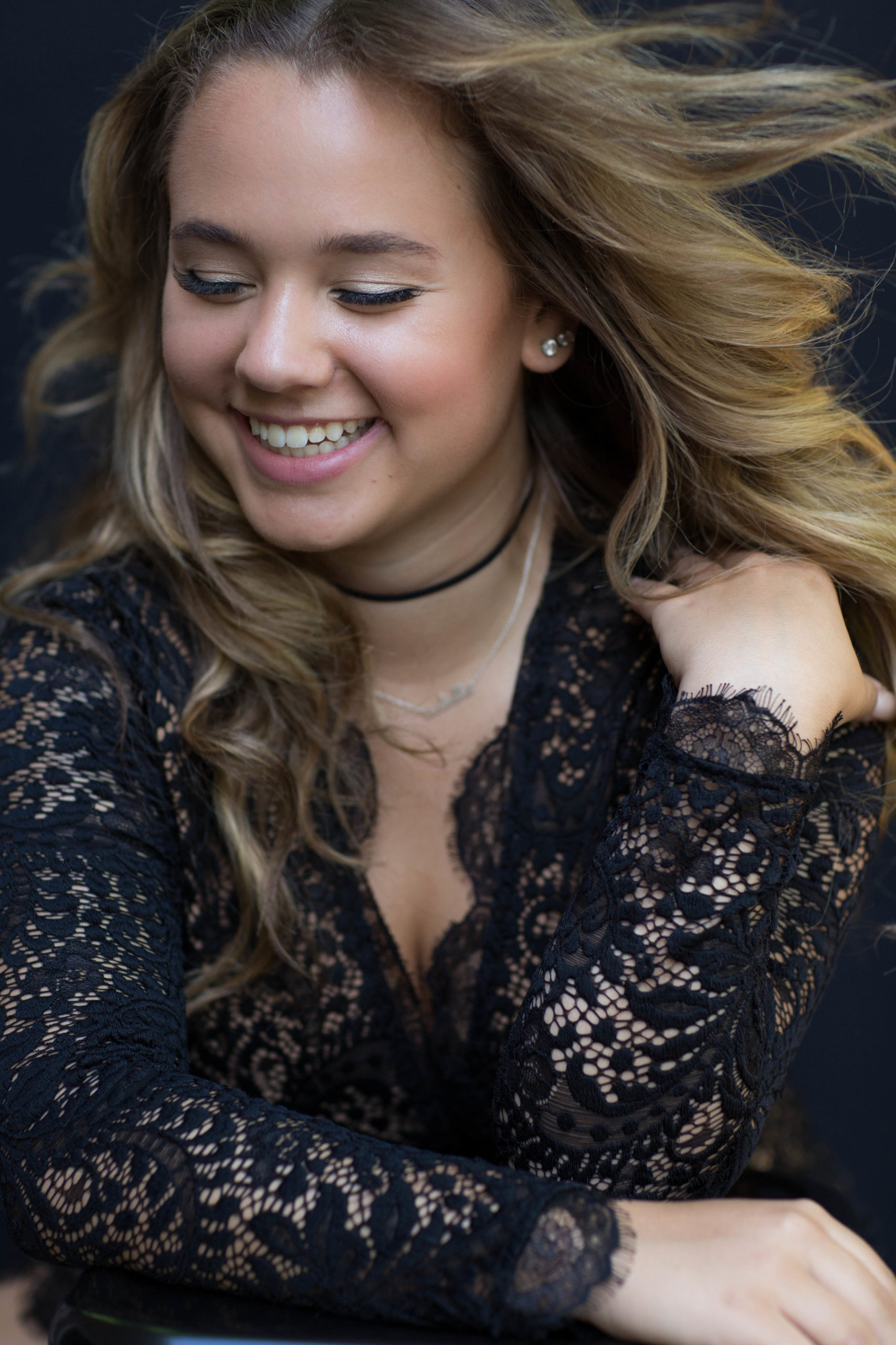 Teen portrait of girl with wind blown hair in a black lace dress